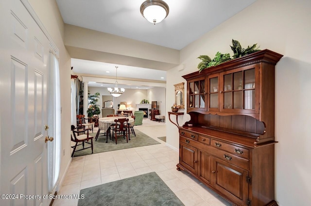 hall featuring a notable chandelier and light tile patterned flooring