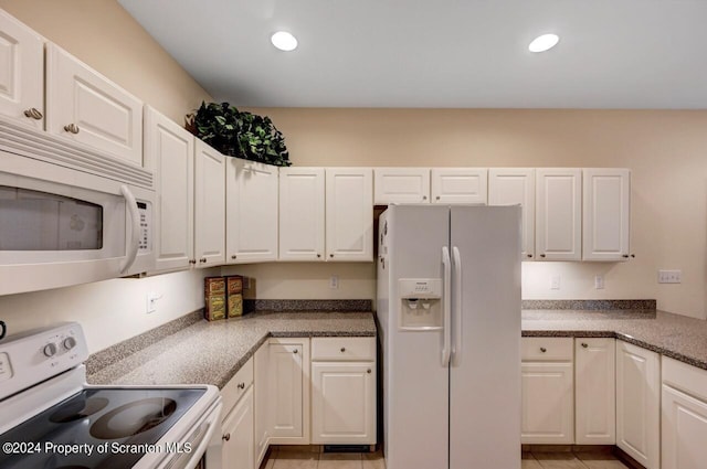 kitchen featuring white cabinetry and white appliances