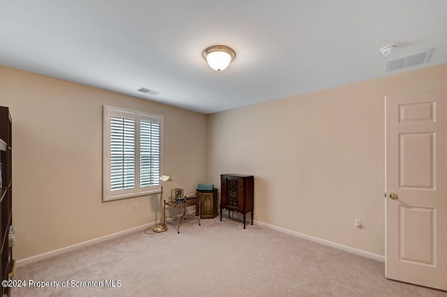 sitting room with light colored carpet