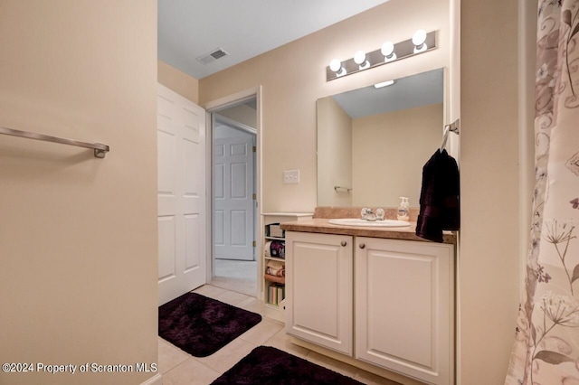 bathroom with tile patterned floors, vanity, and curtained shower