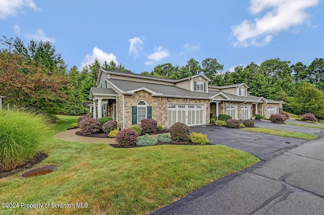 view of front of property with a garage and a front lawn