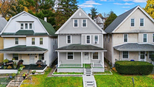 view of front facade with a porch and a front lawn