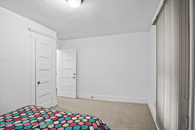 unfurnished bedroom featuring light carpet