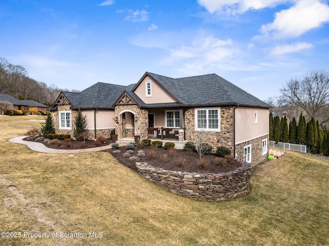 view of front of property featuring stone siding, stucco siding, and a front yard