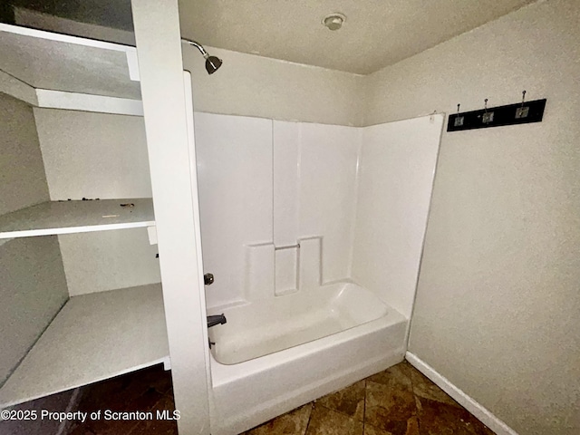 full bathroom with tub / shower combination and baseboards