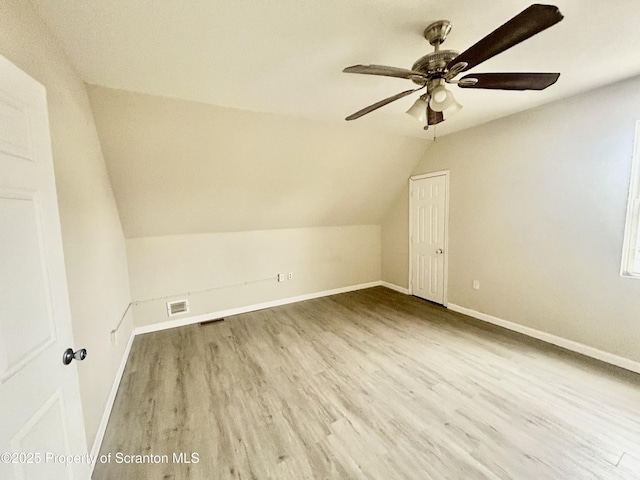 bonus room featuring vaulted ceiling, wood finished floors, visible vents, and baseboards