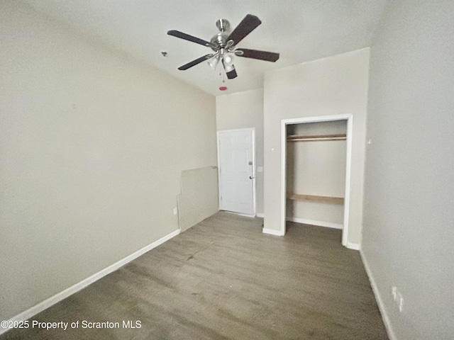 unfurnished bedroom featuring ceiling fan, wood finished floors, a closet, and baseboards