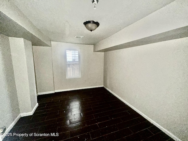 bonus room featuring baseboards and wood finished floors