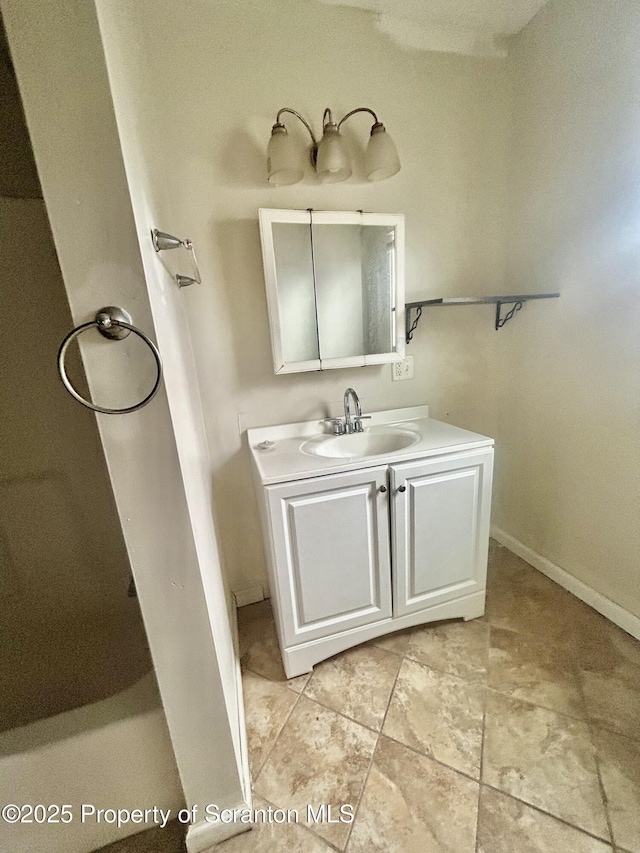 bathroom featuring baseboards and vanity