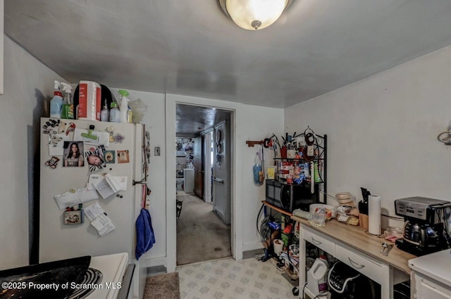 219 N Sumner Ave, Scranton, PA 18504 - kitchen with freestanding refrigerator, black microwave, and light countertops