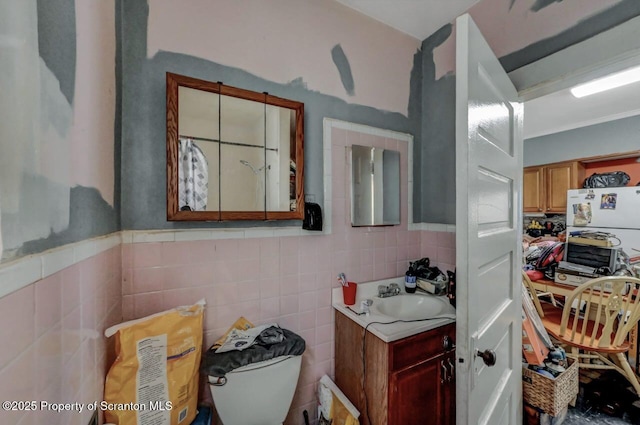 219 N Sumner Ave, Scranton, PA 18504 - bathroom with tile walls, vanity, wainscoting, and toilet