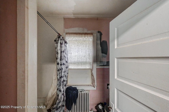 219 N Sumner Ave, Scranton, PA 18504 - bathroom featuring radiator, tile walls, and curtained shower
