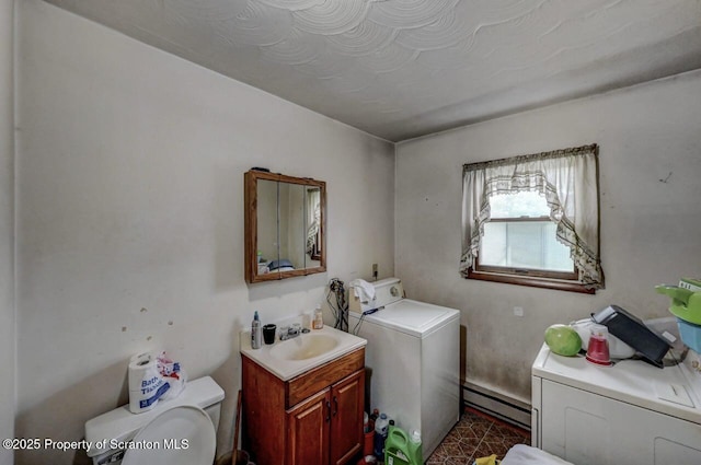 219 N Sumner Ave, Scranton, PA 18504 - washroom featuring baseboard heating, washing machine and clothes dryer, and cabinet space