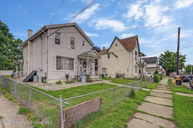 219 N Sumner Ave, Scranton, PA 18504 - view of front of property with a fenced backyard, central air condition unit, and a chimney
