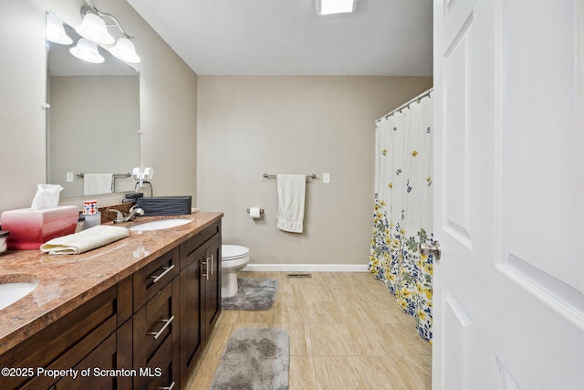 442 Shadow Wood Cir, Archbald, PA 18403 - bathroom with toilet, double vanity, baseboards, and curtained shower