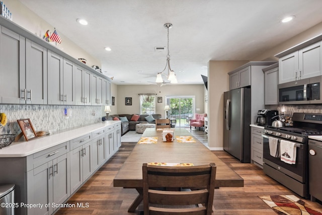 442 Shadow Wood Cir, Archbald, PA 18403 - kitchen featuring stainless steel appliances, gray cabinets, dark wood finished floors, open floor plan, and recessed lighting