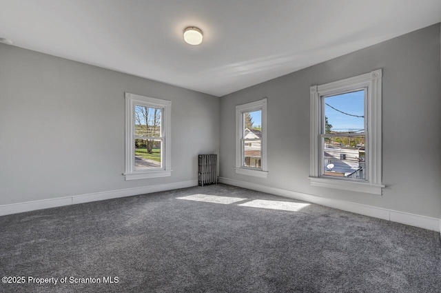 carpeted spare room with baseboards