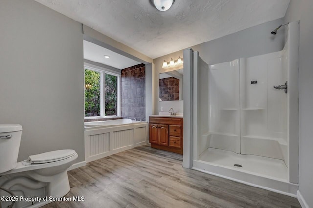 bathroom with a walk in shower, toilet, and wood finished floors