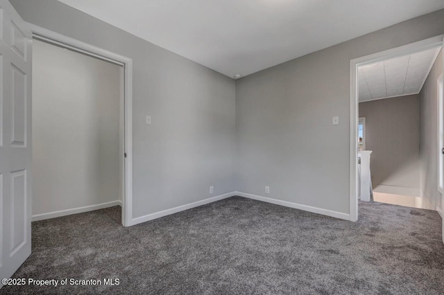 unfurnished bedroom featuring baseboards and carpet
