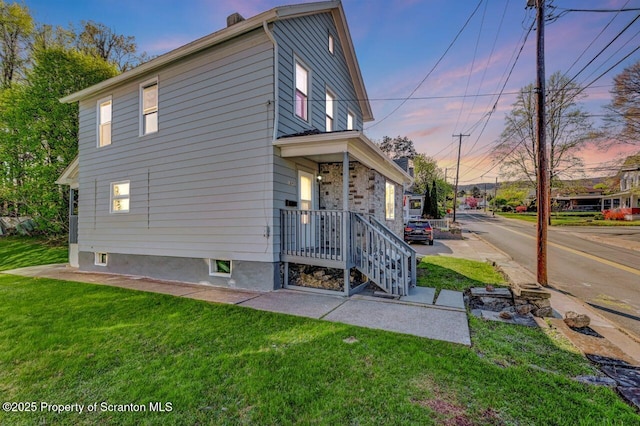 view of property exterior with a yard