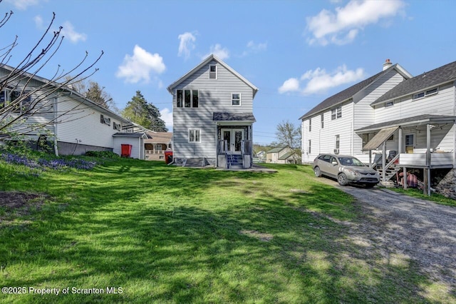 view of front facade featuring french doors and a front yard