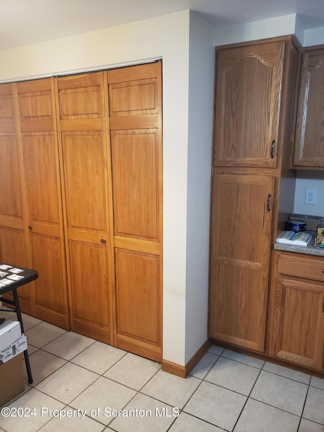 kitchen with light tile patterned flooring