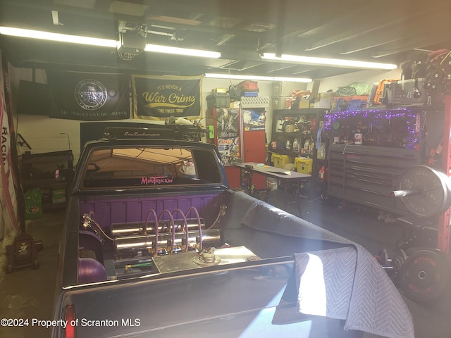 garage featuring a workshop area and a garage door opener