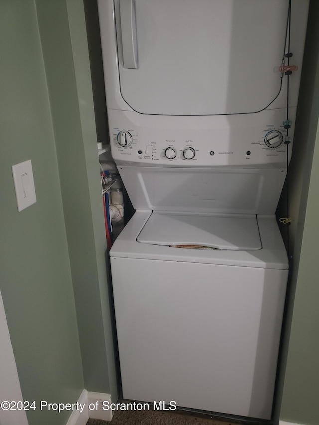 laundry area with stacked washer / dryer