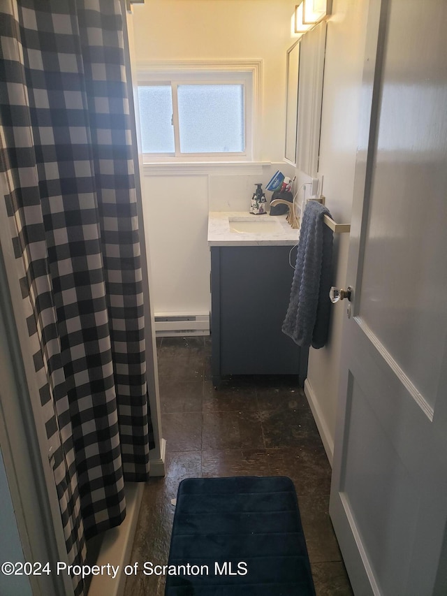 bathroom featuring a shower with curtain, vanity, and a baseboard heating unit