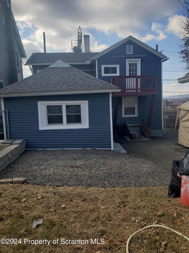 rear view of property featuring a balcony