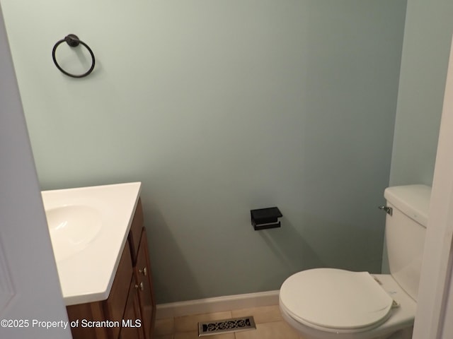 bathroom featuring tile patterned flooring, vanity, and toilet