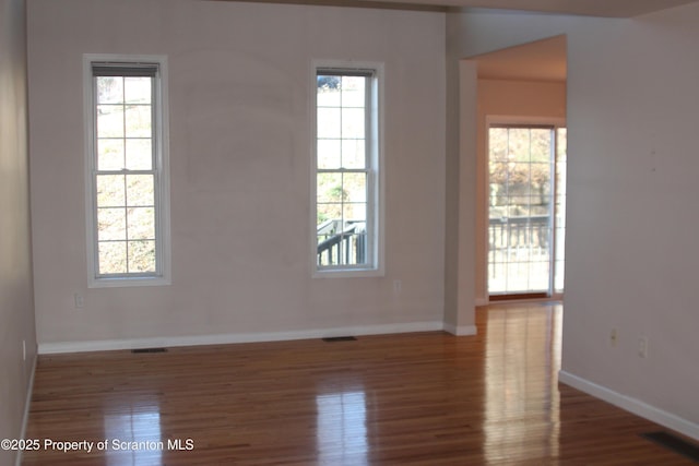 spare room with wood-type flooring