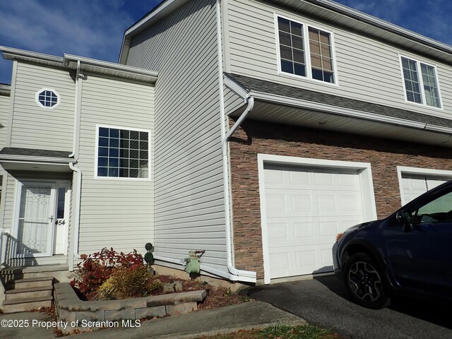 view of side of property with a garage