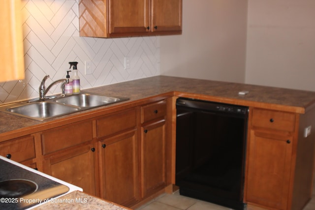 kitchen featuring sink, decorative backsplash, light tile patterned floors, and black dishwasher