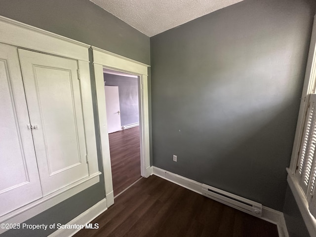 1518 Vine St, Scranton, PA 18510 - spare room with dark wood-type flooring, baseboards, a textured ceiling, and a baseboard radiator