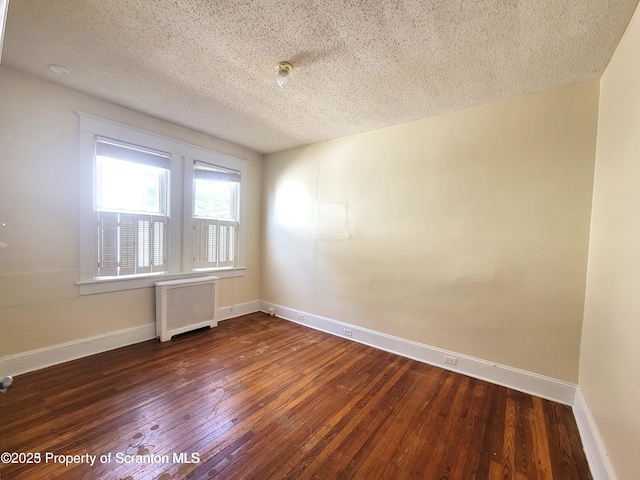 1518 Vine St, Scranton, PA 18510 - empty room featuring radiator, a textured ceiling, hardwood / wood-style floors, and baseboards