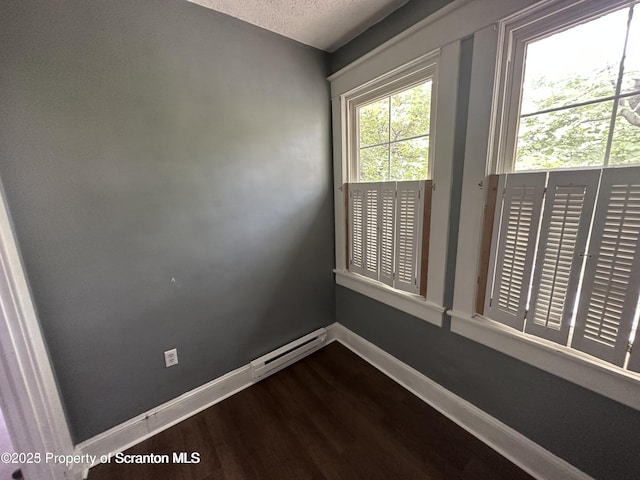 1518 Vine St, Scranton, PA 18510 - spare room with dark wood-style floors, baseboards, a textured ceiling, and baseboard heating