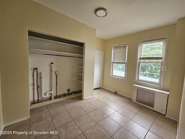 1518 Vine St, Scranton, PA 18510 - laundry area with radiator heating unit, tile patterned flooring, and baseboards