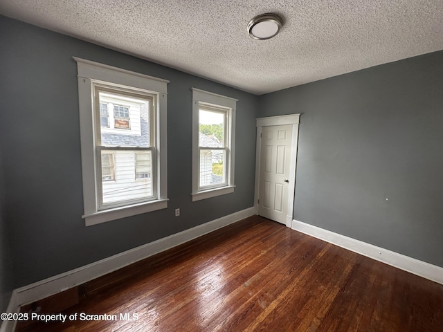 1518 Vine St, Scranton, PA 18510 - empty room featuring dark wood-style flooring, a textured ceiling, and baseboards