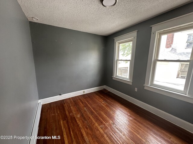 1518 Vine St, Scranton, PA 18510 - spare room with a textured ceiling, dark wood-style flooring, baseboards, and baseboard heating