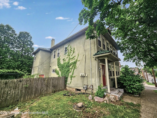1518 Vine St, Scranton, PA 18510 - view of side of home featuring a chimney and stucco siding