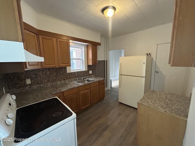 1132 Chestnut St, Allentown, PA 18109 - kitchen with white appliances, tasteful backsplash, wood finished floors, and brown cabinetry