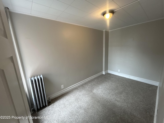 1132 Chestnut St, Allentown, PA 18109 - empty room with radiator heating unit and dark colored carpet