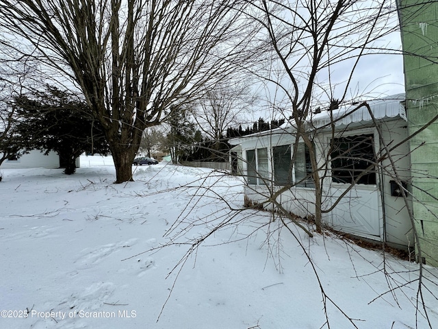 snowy yard with a garage