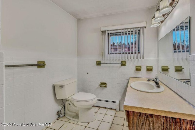 bathroom featuring baseboard heating, tile patterned flooring, tile walls, vanity, and toilet