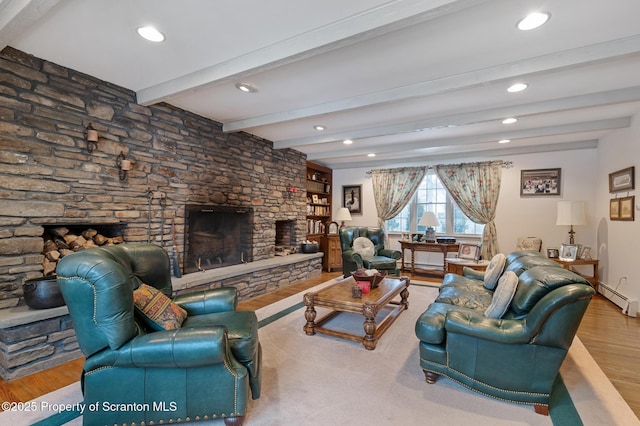 living room featuring beamed ceiling, wood-type flooring, a fireplace, and a baseboard radiator