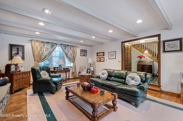 living room featuring light wood-type flooring and beam ceiling