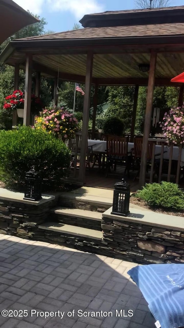 view of patio with area for grilling and a gazebo