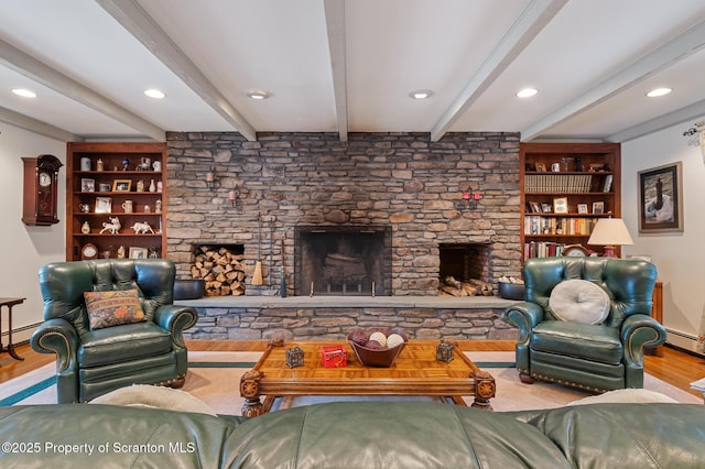 living room featuring a stone fireplace, a baseboard radiator, built in features, beam ceiling, and light hardwood / wood-style floors