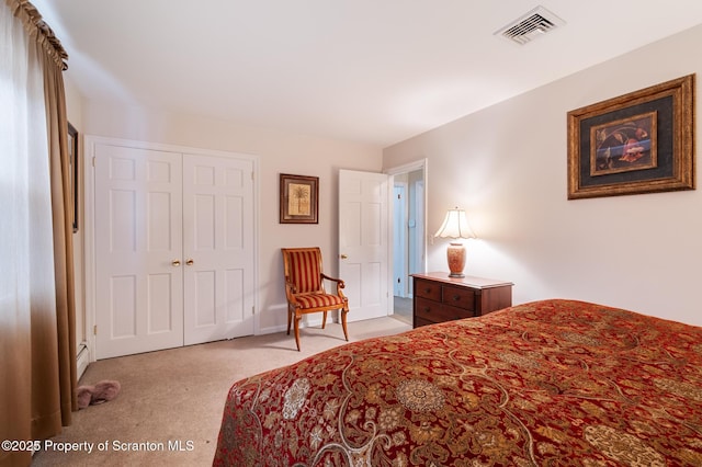 carpeted bedroom featuring a baseboard radiator and a closet